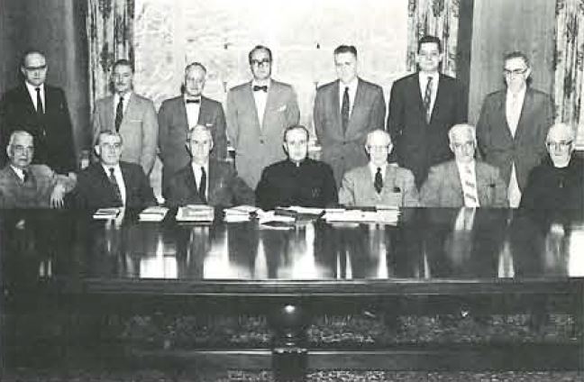 BC Law faculty, 1958: Rev. John A. Tobin, S.J., Professors John D. O'Reilly, William A. O'Keefe, Dean Drinan, Professors Cornelius J. Monihan, Richard S. Sullivan, Warren A. Seavey. Back row: Professors J. Edward Collins, Richard G. Huber, Josepfi; F. McCarthy, Wendell F. Grimes, Steven B. Morrison, Kenneth B. Hughes, Emil Slizewski.